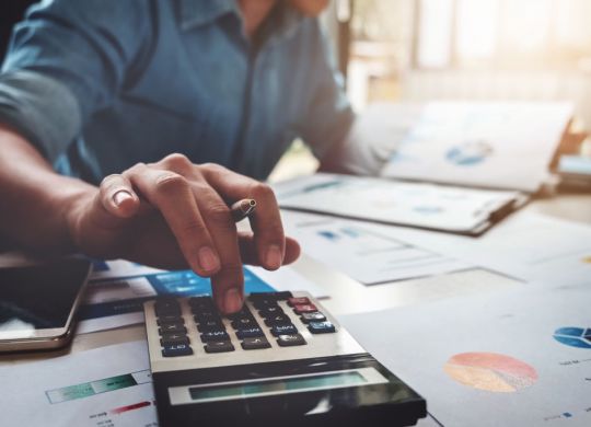 Business accounting concept, Business man using calculator with computer laptop, budget and loan paper in office.