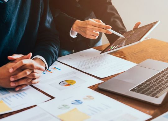 Stock exchange market concept, business team trader looking on tablet and laptop with graphs analysis candle line in office room, diagrams on screen.