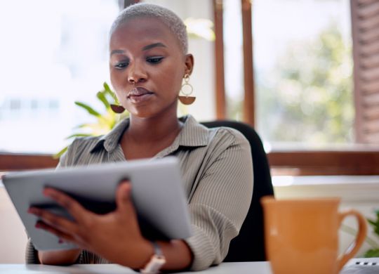 Shot of a young businesswoman using a digital tablet in an office