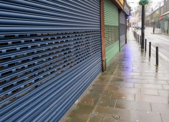 High Street Shops closing down with shutters closed, decline in shopping in Wales, United Kingdom