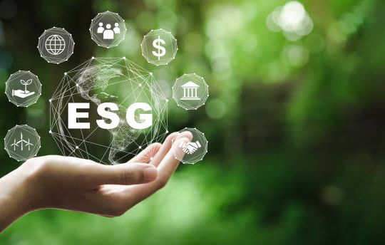 ESG icon concept in the hand for environmental, social, and governance in sustainable and ethical business on the Network connection on a green background.